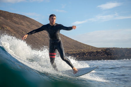 Fuerteventura - March 01, 2019: surfer riding waves on the island of fuerteventura in the Atlantic Oceanのeditorial素材