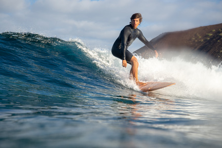 Fuerteventura - March 01, 2019: surfer riding waves on the island of fuerteventura in the Atlantic Oceanのeditorial素材