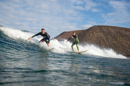 Fuerteventura - March 01, 2019: surfer riding waves on the island of fuerteventura in the Atlantic Oceanのeditorial素材