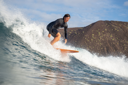 Fuerteventura - March 01, 2019: surfer riding waves on the island of fuerteventura in the Atlantic Oceanのeditorial素材
