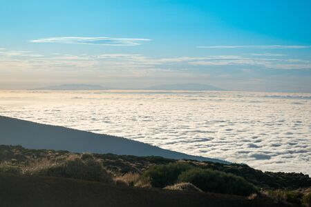 sea of clouds below the summit of Teide volcano in Tenerifeの写真素材