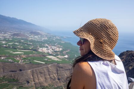 girl looks the landscape of the east coast of the La Palma islandの写真素材
