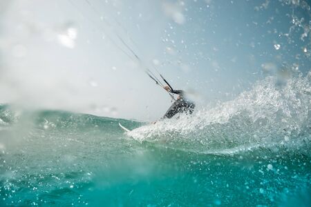 The kite surfer rides the waves of the Atlantic Oceanの写真素材