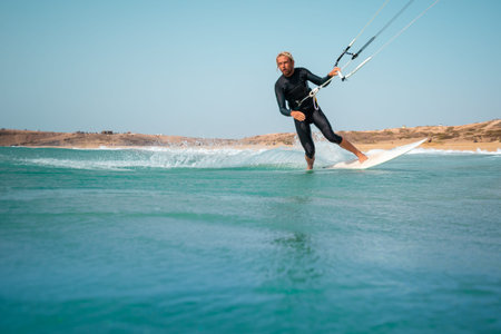 The kite surfer rides the waves of the Atlantic Ocean