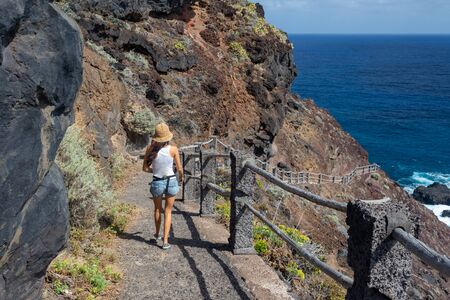 young active woman walks on the pathの写真素材