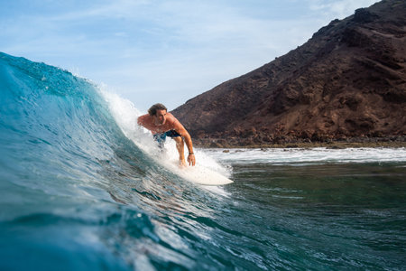 Fuerteventura - September 29, 2019: surfer riding waves on the island of fuerteventura in the...