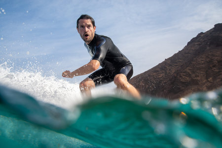 Fuerteventura - September 29, 2019: surfer riding waves on the island of fuerteventura in the...