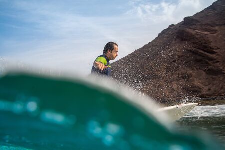 Fuerteventura - September 29, 2019: surfer riding waves on the island of fuerteventura in the Atlantic Oceanのeditorial素材