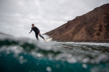 Surfer riding waves on the island of fuerteventuraのeditorial素材