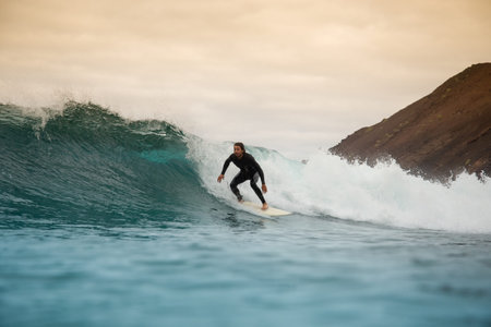 Surfer riding waves on the island of fuerteventura