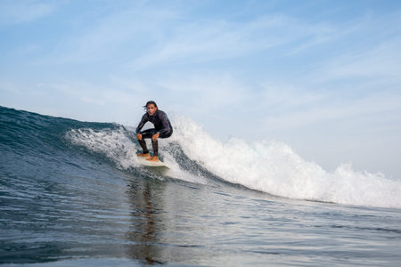 Surfer riding waves on the island of fuerteventura in the Atlantic Ocean, Canary Islandsの写真素材