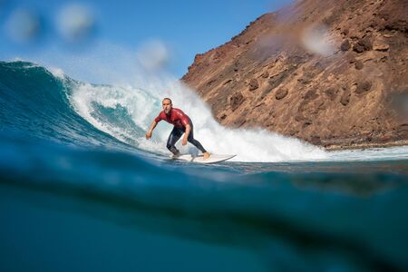 Surfer riding waves on the island of fuerteventuraのeditorial素材