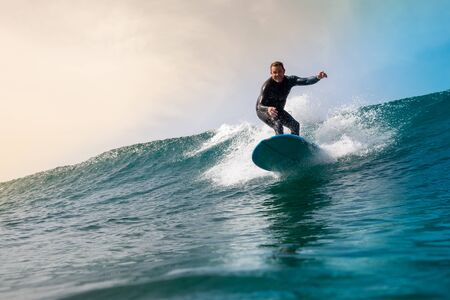Surfer riding waves on the island of fuerteventura in the Atlantic Ocean, Canary Islandsの写真素材