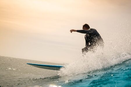 Surfer riding waves on the island of fuerteventura in the Atlantic Ocean, Canary Islandsの写真素材