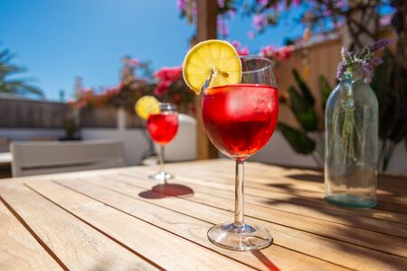 Refreshing Tropical Cocktail Drink on a table in the gardenの写真素材