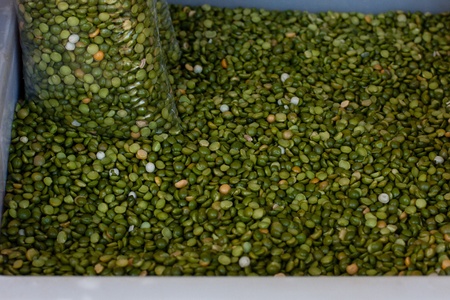 green split peas in a package inside box of split peas in farmer marketの写真素材