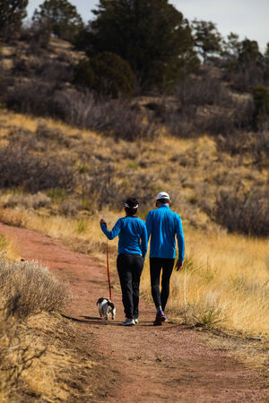 Active couple hiking with dog in Colorado outdoors on a beautiful winter day in Garden of the Gods Parkの写真素材