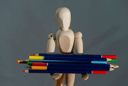 Mannequin with a bunch of colored pencils as a concept for creativityの写真素材