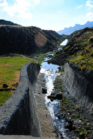 River surrounded by high mountains in a landscape full of mountains and natureの写真素材
