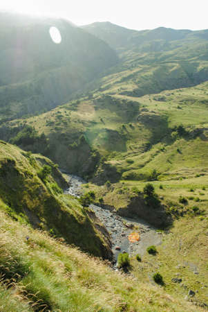 River surrounded by high mountains in a landscape full of mountains and natureの写真素材