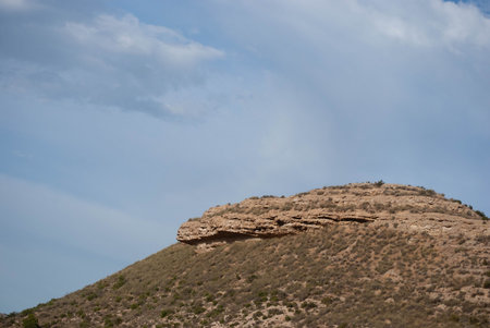 Warm hill full of nature and rocks in a mountainous landscape with blue and clear skies