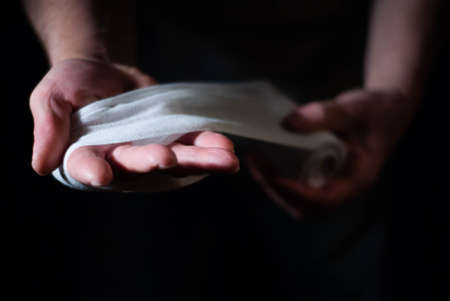 Hands of a boxer with white bandages prepared to fight in a sport battleの写真素材