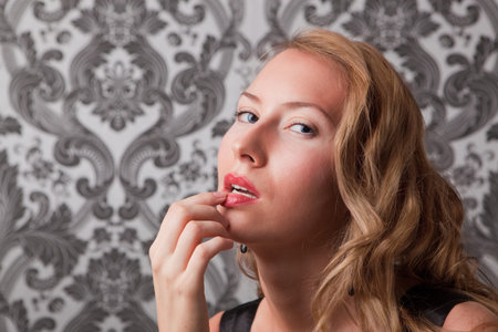 Beautiful blond woman with finger on her lips