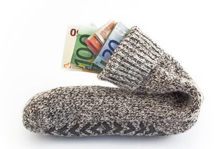Money in a sock isolated on white.の写真素材