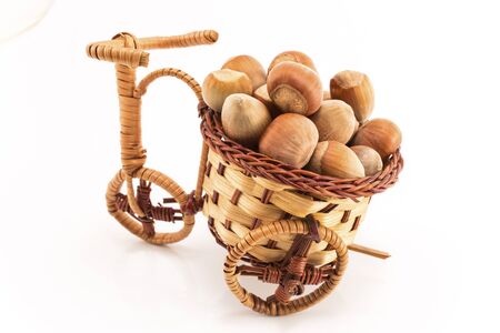 Hazelnuts in a decorative wicker basket.の写真素材