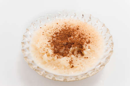 Rice pudding with cinnamon isolated on white.の写真素材