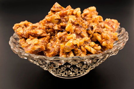 Homemade candies with walnuts in a glass bowl.