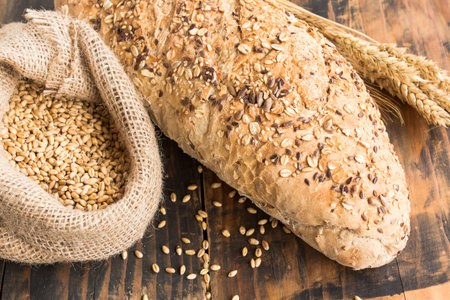 Wholegrain Bread from Whole Wheat, Rye and Flax Seeds on Rustic Wooden Background.