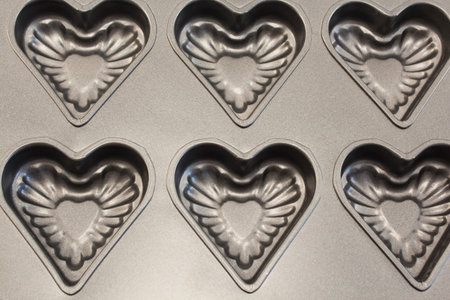 Baking Tray of Cookies in the Shape of Heart as a Background.