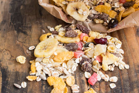 Muesli on Rustic Wooden Background Close Up.の写真素材
