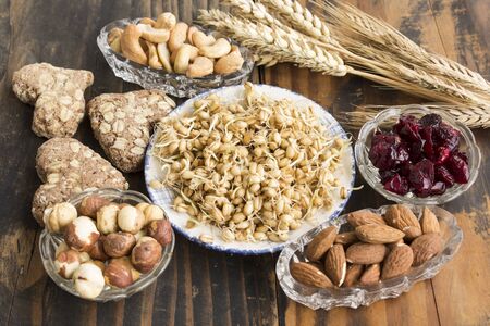 Healthy Food, Nuts, Wheat Germ, Whole Wheat Cookies and Cranberries on Rustic Wooden Background.の写真素材