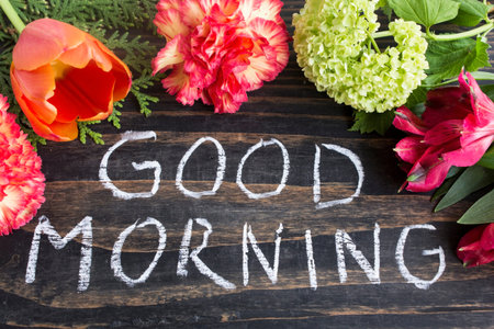 Words Good Morning with Flowers on a Rustic Wooden Background.の写真素材