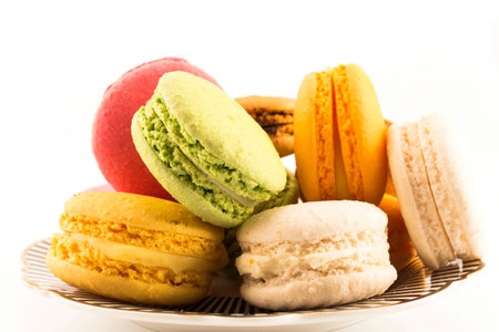 A Pile of Colorful Macaroons on a Plate Isolated on White Background.の写真素材