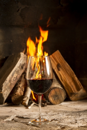 Wine by the fireplace, glasses of wine の写真素材