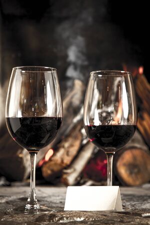 Wine by the fireplace, glasses of wine の写真素材