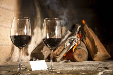 Wine by the fireplace, glasses of wine の写真素材