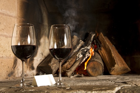 Wine by the fireplace, glasses of wine の写真素材