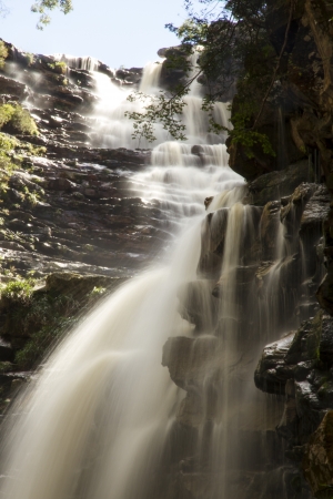 Waterfall and blue stream in the yellow forestの写真素材