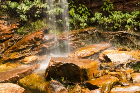Small waterfall falling over rocks in the jungle の写真素材