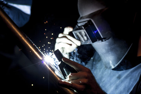 Working man, welding, sparks and smoke  People, industrial 