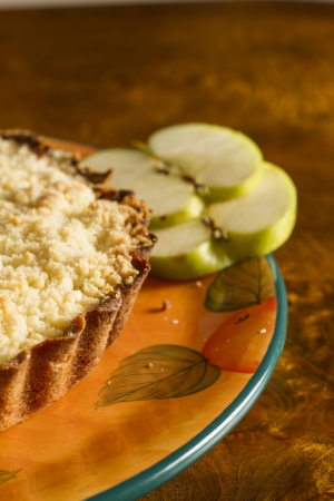 Apple cake with two slices of apple on an old wooden table の写真素材