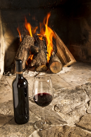 Wine by the fireplace, glasses of wine の写真素材