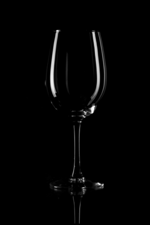 Elegant wine bottle and wine glass, cup, in a black backgroundの写真素材