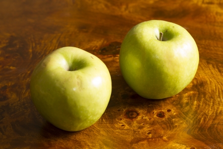 Green Apple over wooden tableの写真素材
