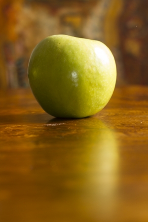 Green Apple over wooden tableの写真素材