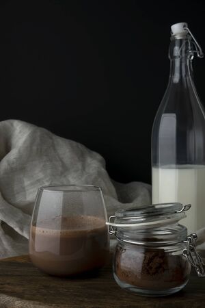 Glass with cacao and a glass jug with milkの写真素材